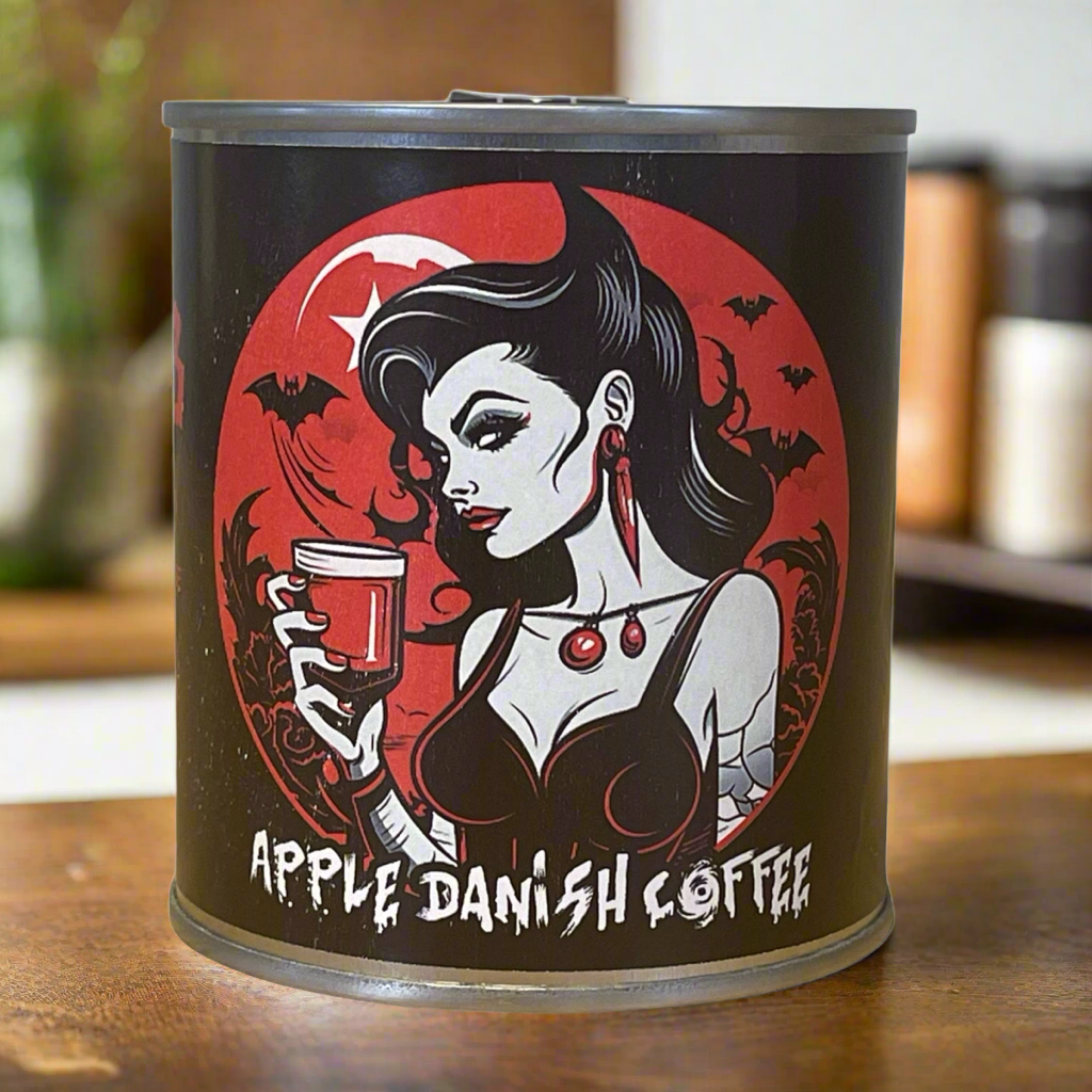 Coffee tin.   Illustration of a woman on the front with big hair in a bob.  She is holding a goblet with red liquid.  